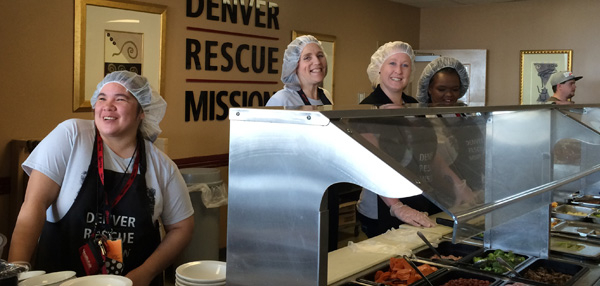 Photo of students volunteering at Denver Rescue Mission serving food to the homeless 